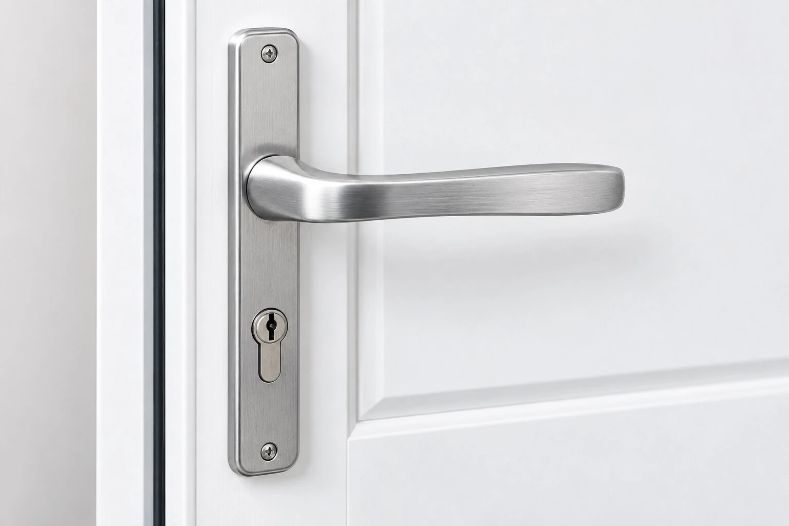 Brushed chrome uPVC replacement door handle fitted to a white door